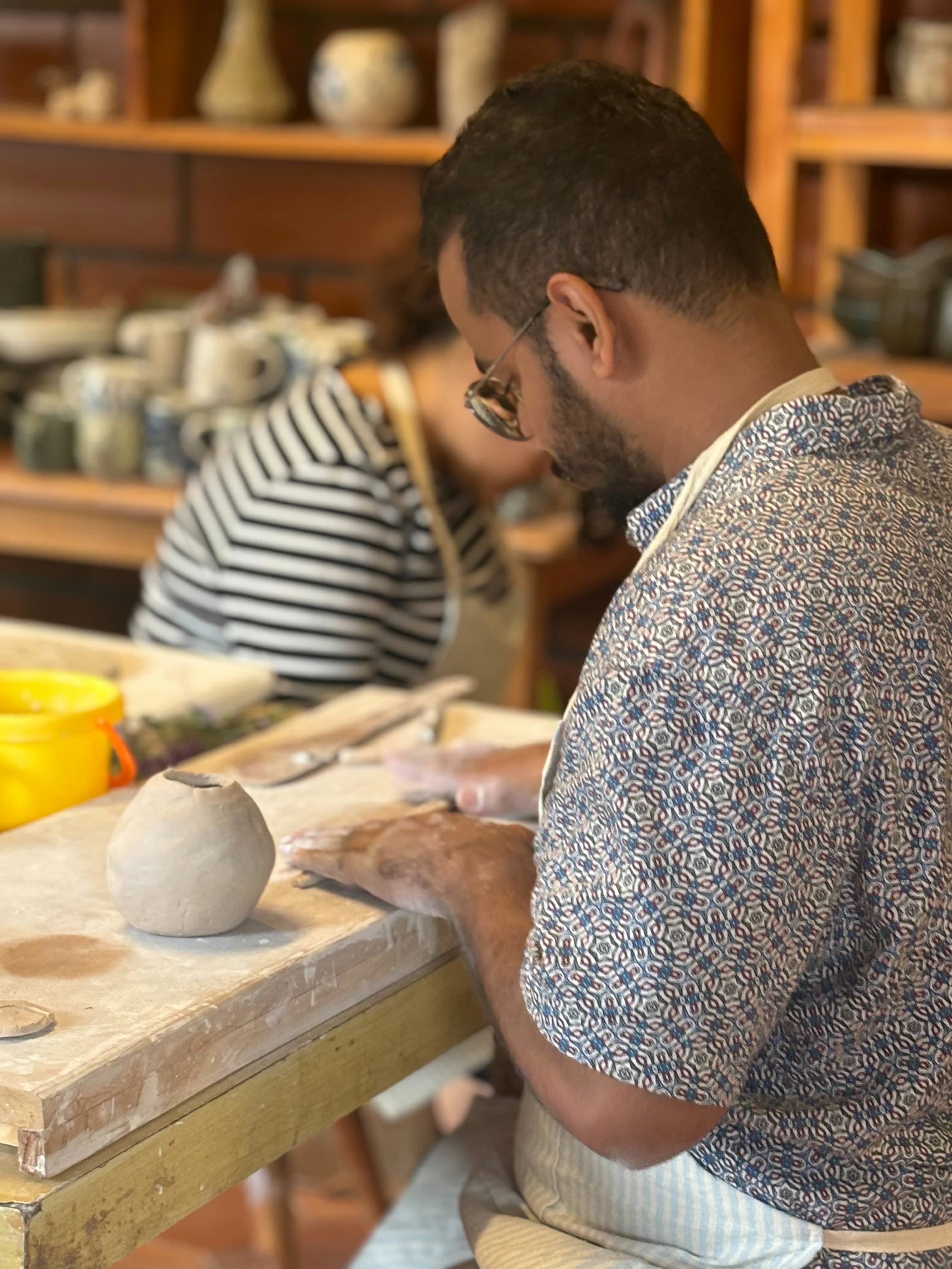 Person working on a pottery wheel